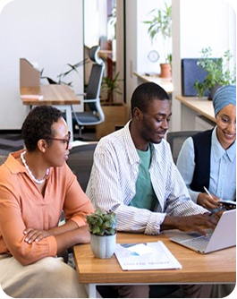 Team of professionals collaborating on a laptop in an office